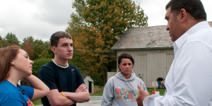 Photo by J. C. Rice from the New York Daily News shows several teens talking to Holloway before helping clean his house